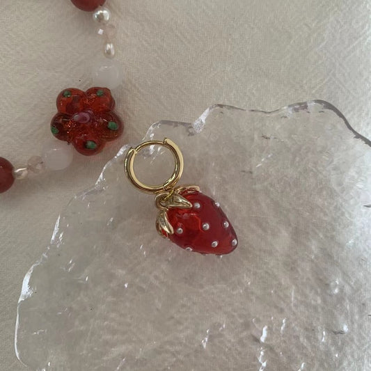 A pair of strawberry earrings