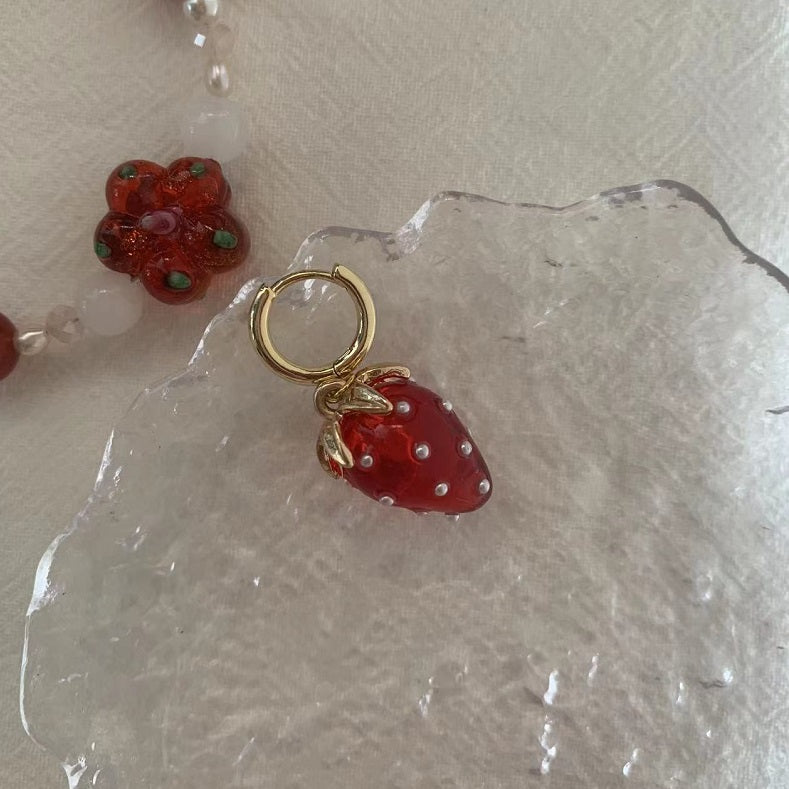 A pair of strawberry earrings